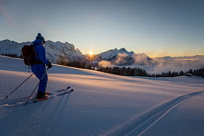 Skifahrer am Berg im Sonnenuntergang